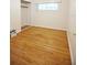 Bright bedroom with hardwood floors and a window overlooking the backyard at 38819 Otis Allen Rd, Zephyrhills, FL 33540