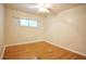 Bedroom featuring hardwood floors, ceiling fan, and a large window at 38819 Otis Allen Rd, Zephyrhills, FL 33540