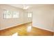Bedroom featuring hardwood floors, large windows, and a mirrored closet at 38819 Otis Allen Rd, Zephyrhills, FL 33540