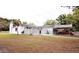A single-story home with a white exterior, complemented by a lush green lawn at 38819 Otis Allen Rd, Zephyrhills, FL 33540