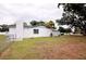 A single story home featuring an attached chimney and a lush green lawn at 38819 Otis Allen Rd, Zephyrhills, FL 33540
