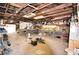 Spacious garage workshop area with multiple workbenches and ample lighting for projects at 38819 Otis Allen Rd, Zephyrhills, FL 33540