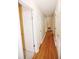 Hallway with wood floor and some white doors at 38819 Otis Allen Rd, Zephyrhills, FL 33540