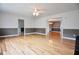 Open concept living room boasts gleaming hardwood floors and neutral color palette at 38819 Otis Allen Rd, Zephyrhills, FL 33540
