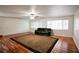 Spacious living room with brick wall, dark wood floor, large area rug, and lots of natural light at 38819 Otis Allen Rd, Zephyrhills, FL 33540