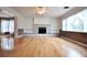 Bright living room features large windows, built-in shelving, and a brick fireplace at 38819 Otis Allen Rd, Zephyrhills, FL 33540