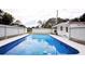 Refreshing in-ground swimming pool with concrete decking and privacy fence, perfect for outdoor relaxation at 38819 Otis Allen Rd, Zephyrhills, FL 33540