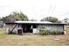View of the exterior of the shed with an open doorway and various plants scattered around at 38819 Otis Allen Rd, Zephyrhills, FL 33540