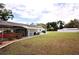 Wide backyard featuring a covered carport and view of the home at 38819 Otis Allen Rd, Zephyrhills, FL 33540
