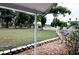 Spacious yard surrounded by mature trees with a stone-lined garden bed at 38819 Otis Allen Rd, Zephyrhills, FL 33540