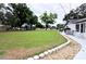 View of the expansive yard with a stone-lined walkway leading to the house at 38819 Otis Allen Rd, Zephyrhills, FL 33540