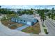 Aerial view of a single-Gathering home with a gray roof and tropical landscaping at 410 Virginia Ave, Madeira Beach, FL 33708
