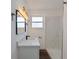 This bathroom features a new vanity and lighting, with a remodeled tile shower at 410 Virginia Ave, Madeira Beach, FL 33708