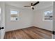 Bedroom features laminate flooring, neutral walls, recessed lighting, a fan, and two windows at 410 Virginia Ave, Madeira Beach, FL 33708