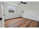 This bedroom offers hardwood floors and natural light from its two windows at 410 Virginia Ave, Madeira Beach, FL 33708