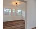 Dining room features beautiful laminate flooring, recessed lighting, an updated light fixture, and natural light at 410 Virginia Ave, Madeira Beach, FL 33708