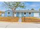 Charming blue single-Gathering home with a well-maintained front yard and a walkway leading to the front door at 410 Virginia Ave, Madeira Beach, FL 33708