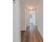 Hallway features laminate flooring, white walls, closet, and leads to rooms at the end of the hall at 410 Virginia Ave, Madeira Beach, FL 33708