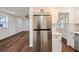 Open kitchen with stainless steel appliances, quartz countertops, and ample cabinet space flows to living area at 410 Virginia Ave, Madeira Beach, FL 33708