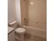 Clean bathroom featuring a tub and shower, toilet, and basic vanity area at 4111 Ashford Green Pl # B203, Tampa, FL 33613