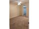 Cozy bedroom featuring plush carpeting, neutral walls, a ceiling fan, and a walk-in closet at 4111 Ashford Green Pl # B203, Tampa, FL 33613