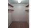 Spacious walk-in closet providing ample storage space with carpet floors and open shelving at 4111 Ashford Green Pl # B203, Tampa, FL 33613