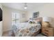 Cozy bedroom featuring a queen bed, decorative pillows, and a ceiling fan, providing a peaceful retreat at 4492 Kingston Dr, Hernando Beach, FL 34607