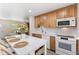 Modern kitchen with quartz countertops, stainless steel appliances, and an island with seating overlooking the living room at 4492 Kingston Dr, Hernando Beach, FL 34607