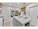 Modern kitchen with quartz countertops, stainless steel appliances, and an island with seating at 4492 Kingston Dr, Hernando Beach, FL 34607