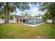 Aerial view of a home featuring a screened pool, patio, and fenced yard at 4509 Grainary Ave, Tampa, FL 33624