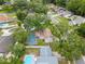 Aerial view of a home's backyard featuring a screened pool and mature landscaping at 4509 Grainary Ave, Tampa, FL 33624