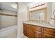 Bright bathroom featuring a granite countertop vanity with ample lighting and an enclosed shower at 4509 Grainary Ave, Tampa, FL 33624