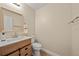 Updated half bath features a wood vanity, modern fixtures, and a decorative mirror at 4509 Grainary Ave, Tampa, FL 33624