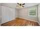 Well-lit bedroom featuring hardwood floors, a ceiling fan, and a spacious closet at 4509 Grainary Ave, Tampa, FL 33624