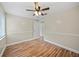 Inviting bedroom showcasing hardwood floors, ceiling fan, and convenient closet space at 4509 Grainary Ave, Tampa, FL 33624