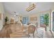Open-concept living space featuring a dining area with a modern chandelier and natural light at 4509 Grainary Ave, Tampa, FL 33624