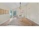 Dining area with modern light fixture, neutral decor, and a large window at 4509 Grainary Ave, Tampa, FL 33624