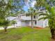 Beautiful two-story home with lush lawn and landscaping, mature trees, and inviting curb appeal at 4509 Grainary Ave, Tampa, FL 33624
