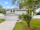 Charming two-story home with a well-manicured lawn and attached garage at 4509 Grainary Ave, Tampa, FL 33624