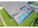 Aerial view of backyard pool inside of a screened-in patio at 4531 River Overlook Dr, Valrico, FL 33596