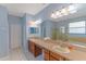 Bathroom with double sinks and vanity, large mirror, soaking tub, and glass enclosed shower at 4531 River Overlook Dr, Valrico, FL 33596