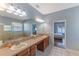 Bathroom with double sinks, large mirror, soaking tub, glass shower and bedroom access at 4531 River Overlook Dr, Valrico, FL 33596