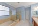 Bathroom features a soaking tub and glass-enclosed shower, with a vanity area and tiled floor at 4531 River Overlook Dr, Valrico, FL 33596