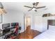 Spacious bedroom features wood floors, ceiling fan, and a modern desk with computer setup at 4531 River Overlook Dr, Valrico, FL 33596