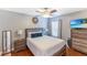 Cozy bedroom features hardwood floors, neutral colors, updated ceiling fan, and stylish furnishings at 4531 River Overlook Dr, Valrico, FL 33596