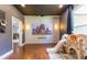 Bonus room with home theater setup, hardwood floors, and playful decor at 4531 River Overlook Dr, Valrico, FL 33596