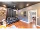 Bonus room with theater seating, projector screen, hardwood flooring and built-in shelving at 4531 River Overlook Dr, Valrico, FL 33596