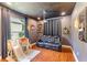 Bonus room with theater seating, a movie projector, and hardwood flooring with unique shelving at 4531 River Overlook Dr, Valrico, FL 33596