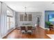 Open-concept dining room with modern furniture, chandelier, and hardwood flooring at 4531 River Overlook Dr, Valrico, FL 33596