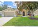 Charming single-story home with a well-manicured lawn and a mature magnolia tree at 4531 River Overlook Dr, Valrico, FL 33596
